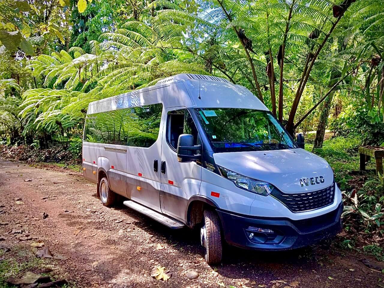 http://White%20Iveco%20minibus%20in%20a%20lush%20tropical%20forest%20during%20a%20Private%20Costa%20Rica%20airport%20transportation%20service