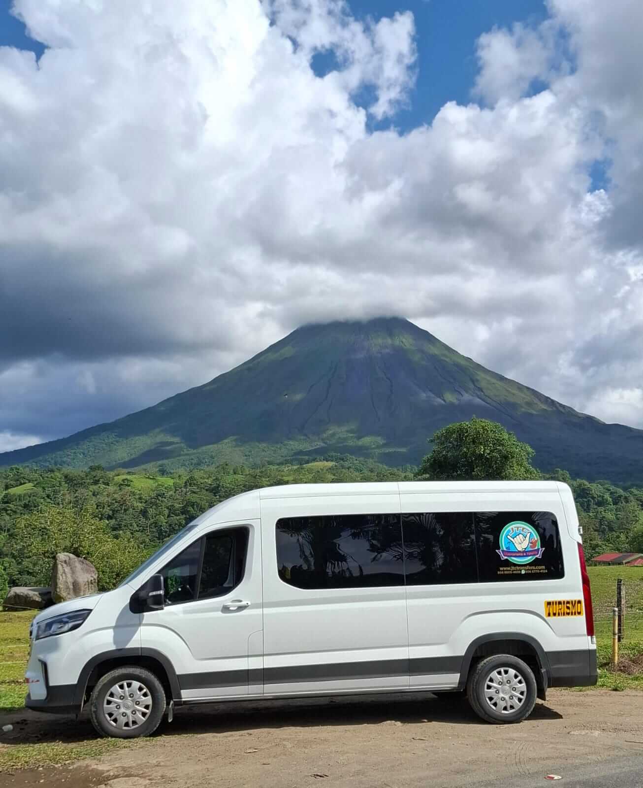 http://White%20JTC%20Transfer%20van%20offering%20Private%20Costa%20Rica%20airport%20transportation%20service.%20Parked%20with%20Arenal%20Volcano%20in%20the%20background