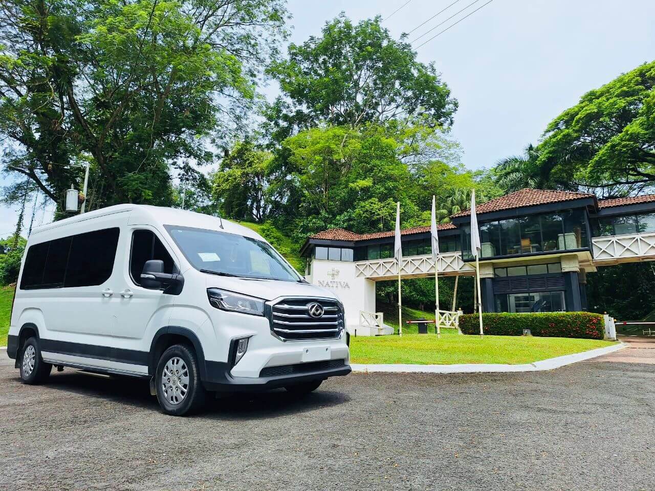 White private shuttle van parked outside Nativa Resort in Jaco, Costa Rica
