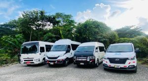 Private Costa Rica airport transportation vans parked in a lush tropical setting