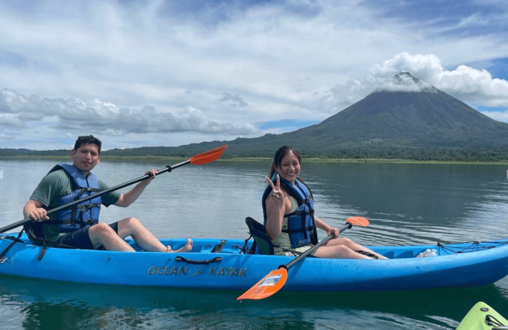 Two kayakers paddling on Lake Arenal with Arenal Volcano in the background — kayak tour La Fortuna Costa Rica