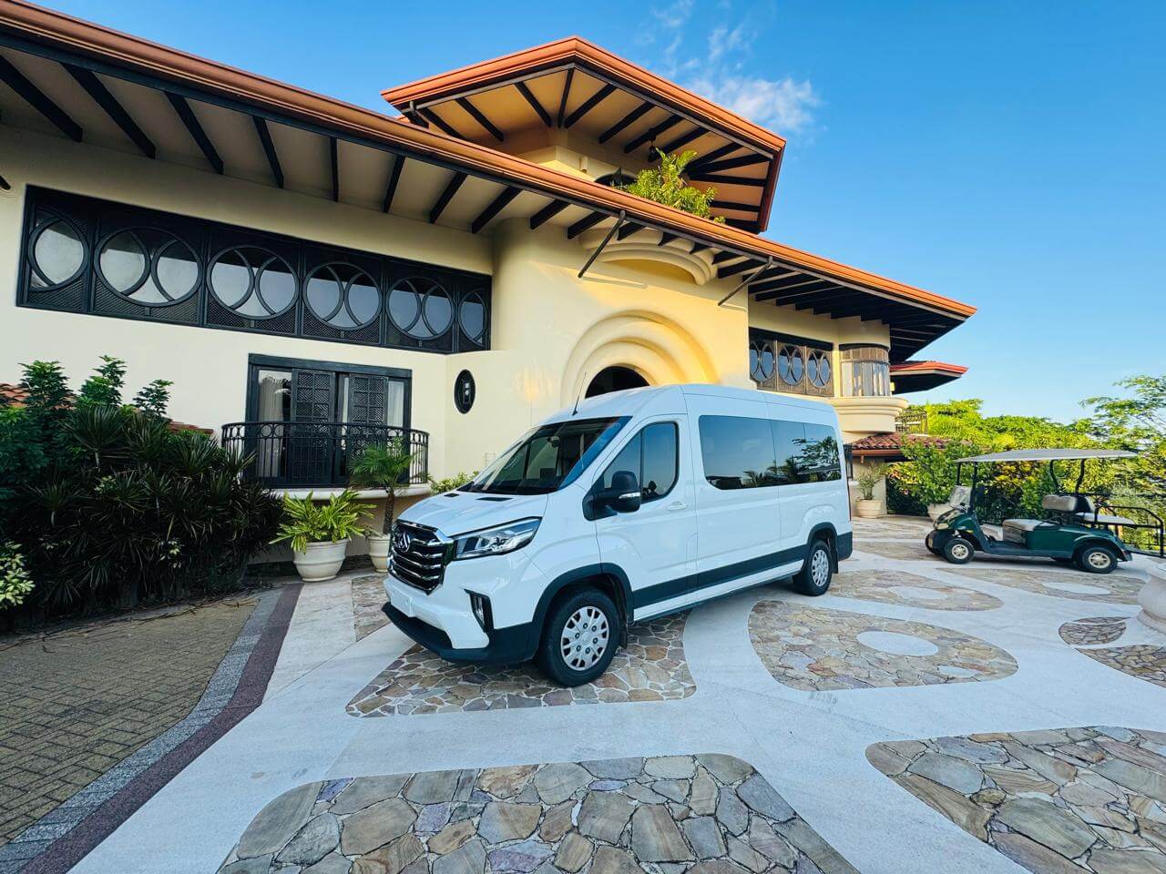 http://White%20private%20shuttle%20van%20parked%20at%20a%20tropical%20villa%20entrance%20—%20private%20shuttle%20from%20San%20Jose%20to%20Quepos%20with%20professional%20driver